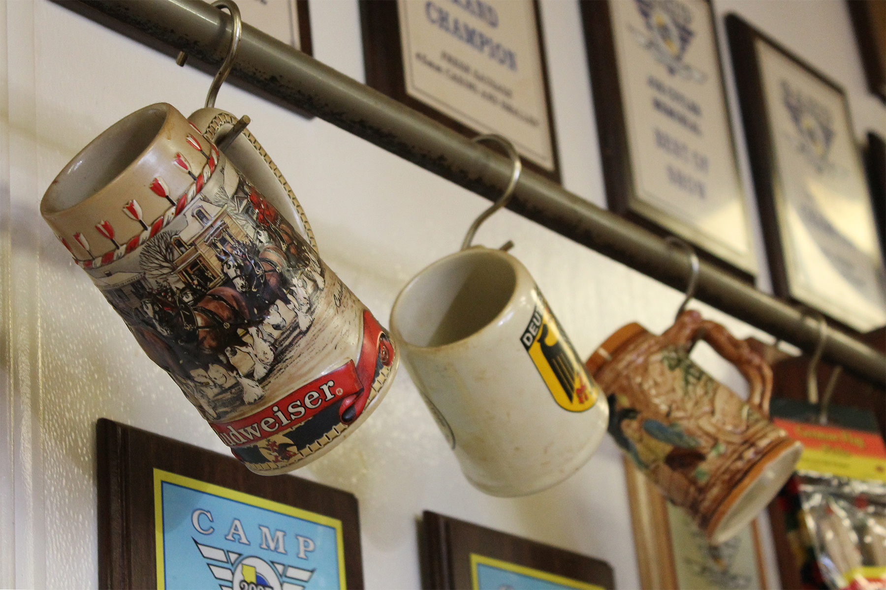 Traditional beer steins hang from a rack on the wall of Muller's shop, collected from around Germany. (Photos by Justina Sharp)